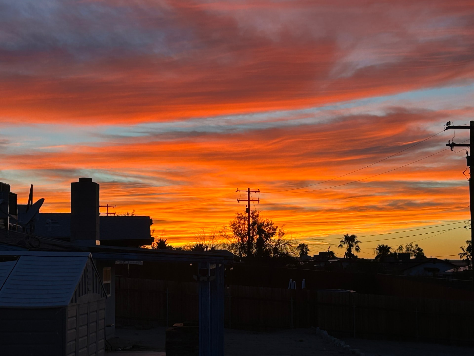 Fiery orange and violet sunset sky over Southern California rooftops