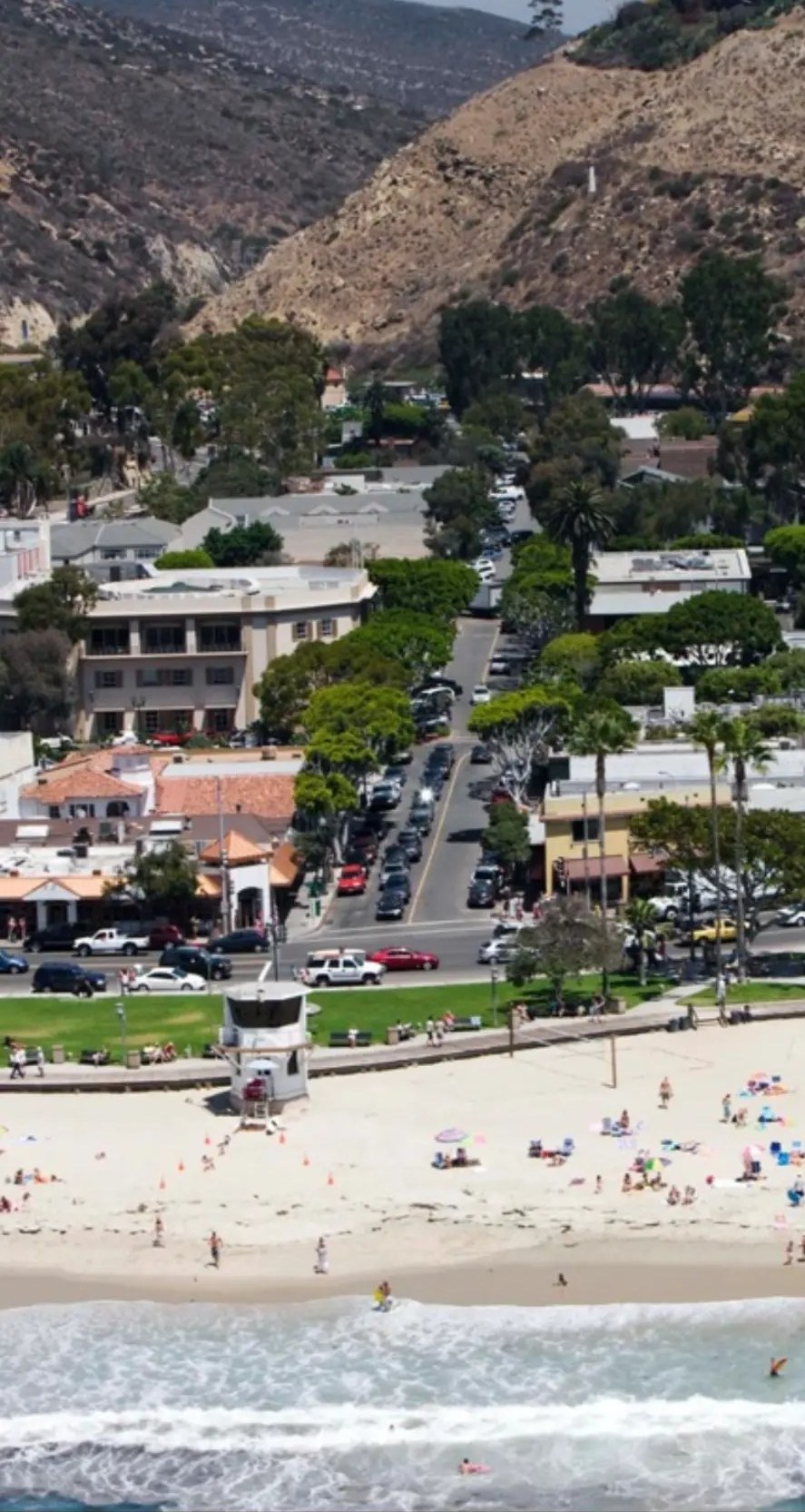 Aerial view of downtown Laguna Beach village meeting Main Beach